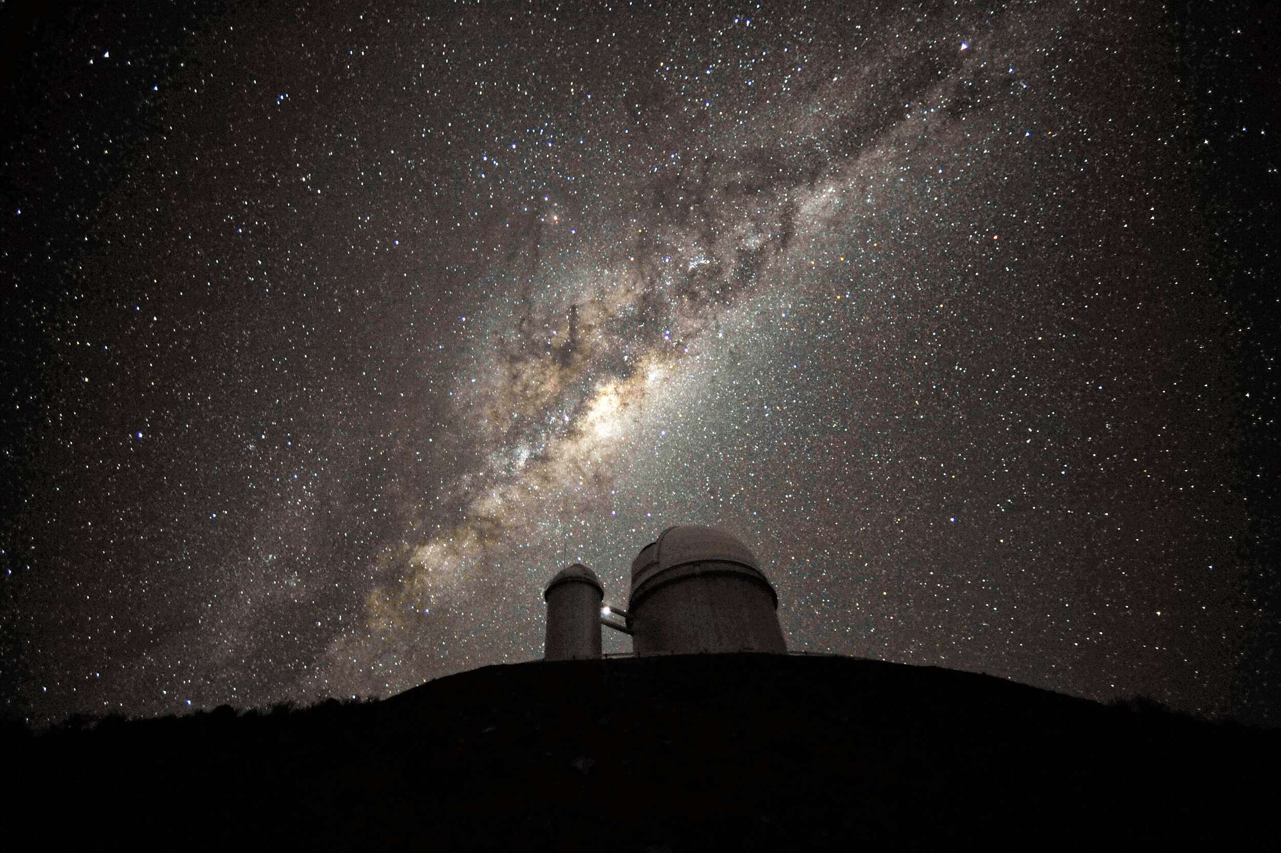 The milky way in the dark sky above a watch tower