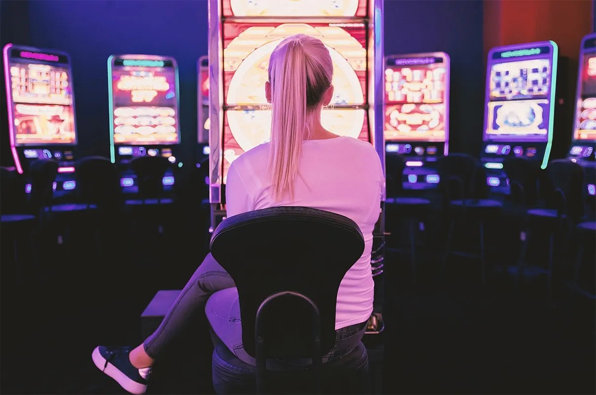 A woman seated at a slot machine